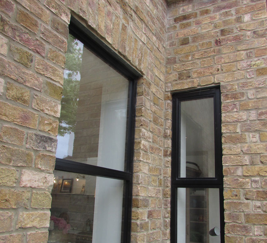 Open industrial aluminium doors on a rear elevation